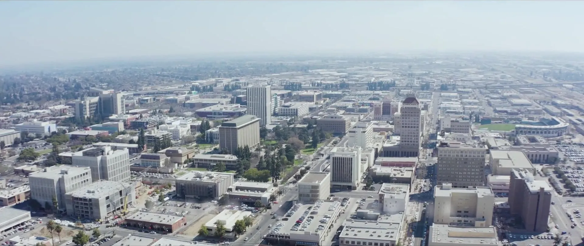 Aerial view over a city's downtown on a hazy day.